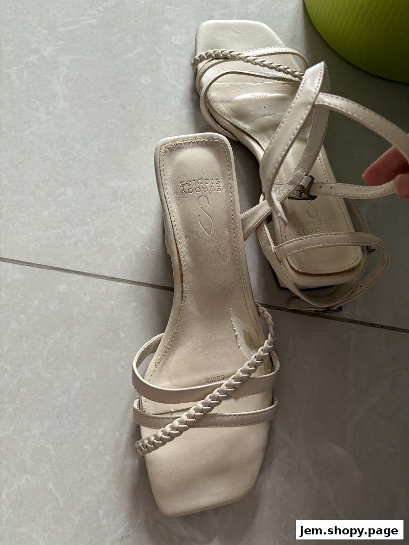 A pair of cream-colored strappy sandals with braided details from Sunday Staples.