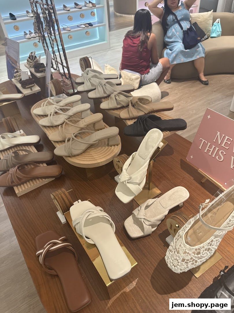 A display of stylish sandals and shoes in a retail store, with customers browsing.
