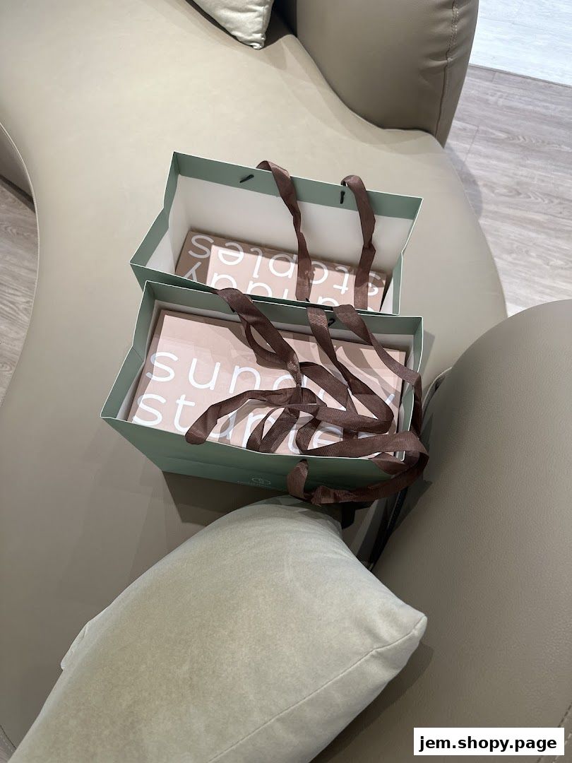 Two shopping bags from Sunday Staples are placed on a sofa.