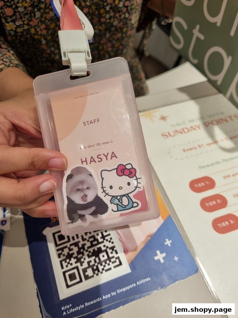 A staff ID card for Sunday Staples featuring a dog and Hello Kitty sticker.