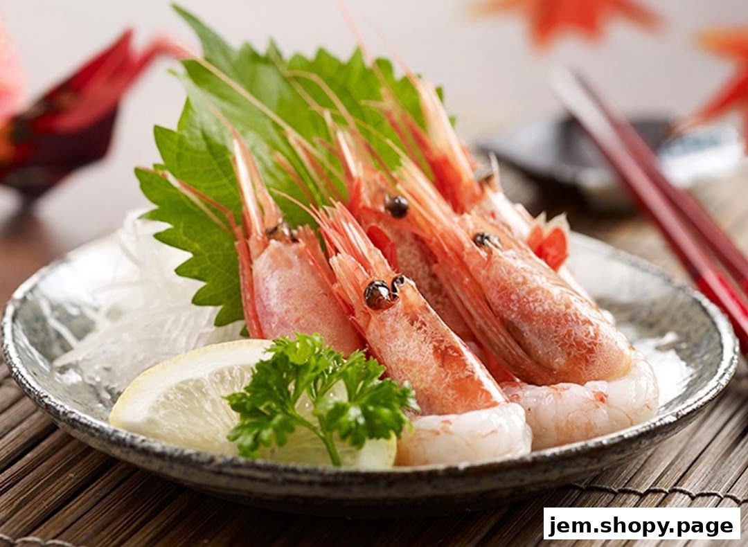 A plate of fresh shrimp sashimi served with lemon and garnishes.