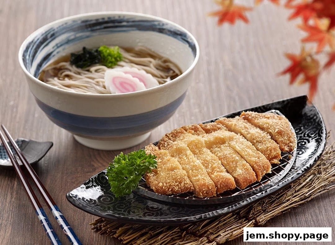 A bowl of soba noodles and a plate of crispy fried pork cutlet are presented.