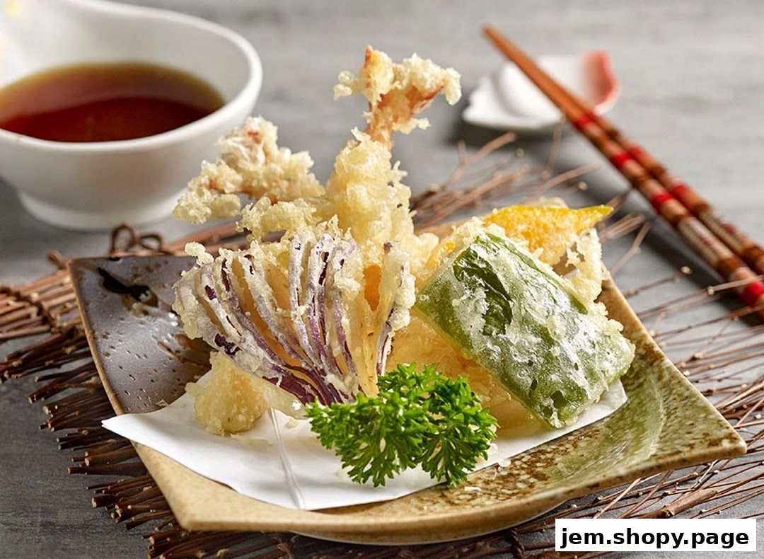A plate of assorted tempura with dipping sauce and chopsticks.