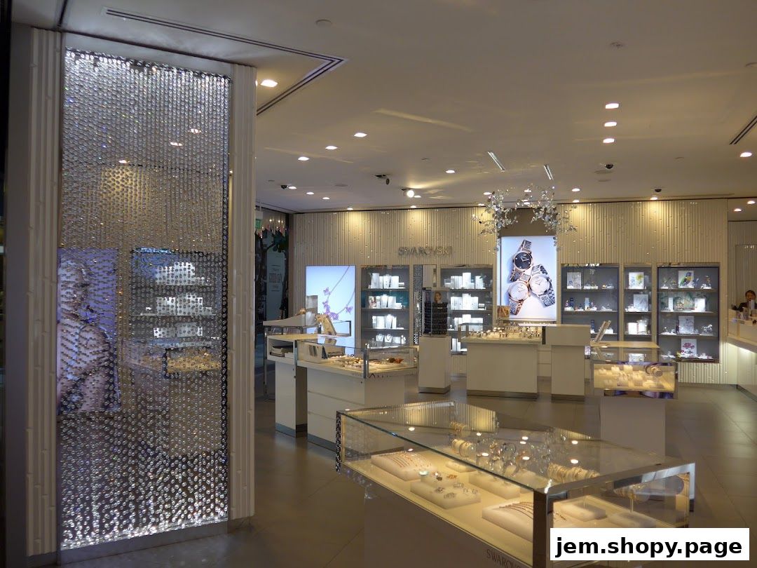 Interior view of a Swarovski store showcasing jewelry and watches in display cases.