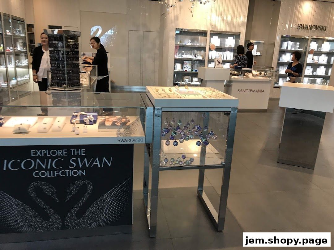 Interior of a Swarovski store showcasing jewelry displays and staff.