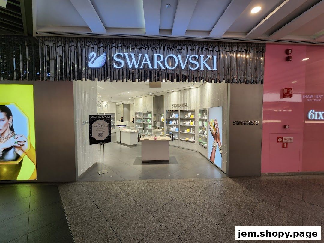The entrance to a Swarovski jewelry store with illuminated signage and displays.