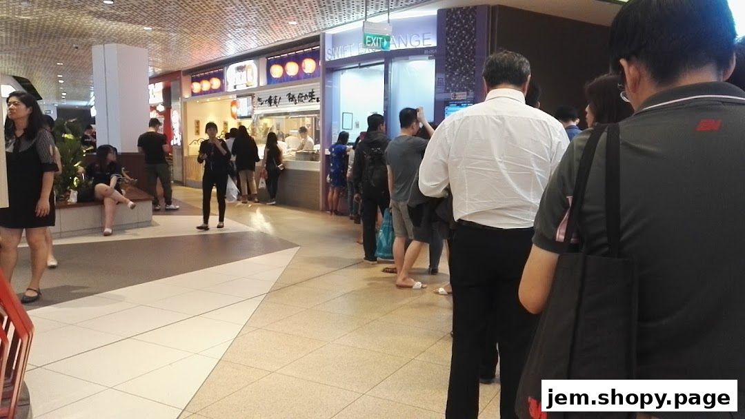 A queue of people waiting outside the Swift Exchange shop in a mall.