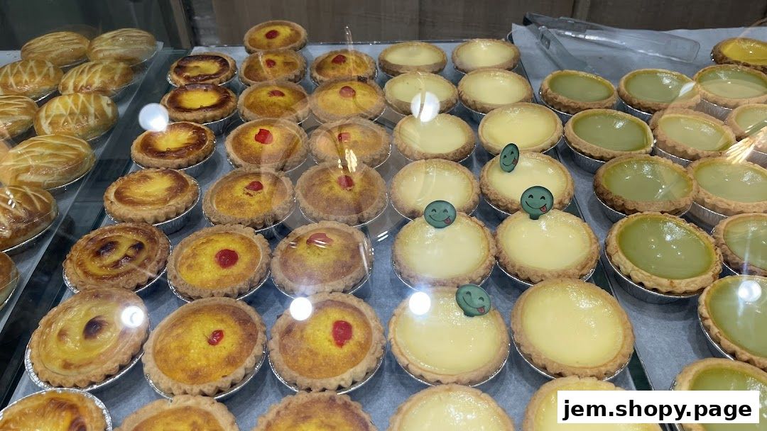 A display of various freshly baked tarts and pastries in a bakery.