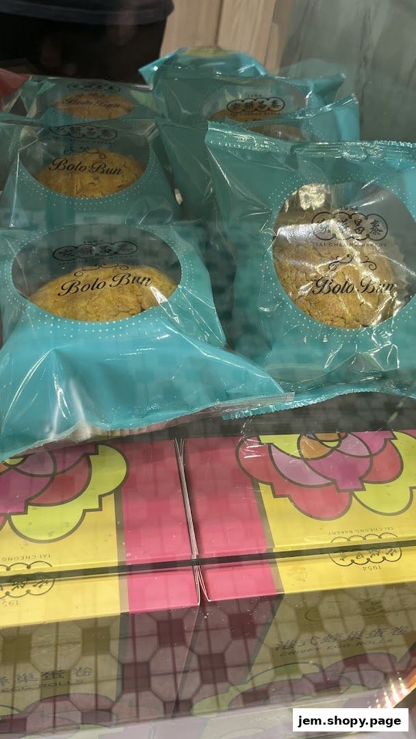 Individually wrapped Bolo Buns and boxes of Crispy Egg Rolls from Tai Cheong Bakery.