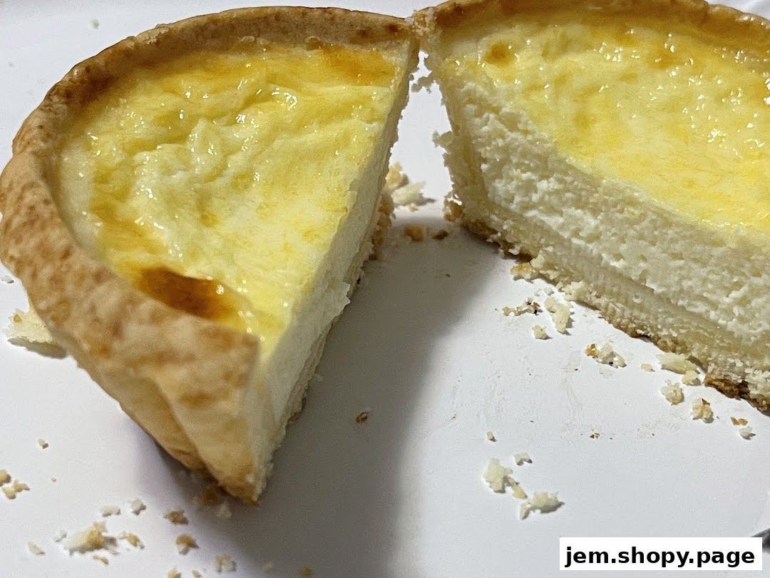 A close-up shot of a sliced creamy cheesecake with a golden crust.