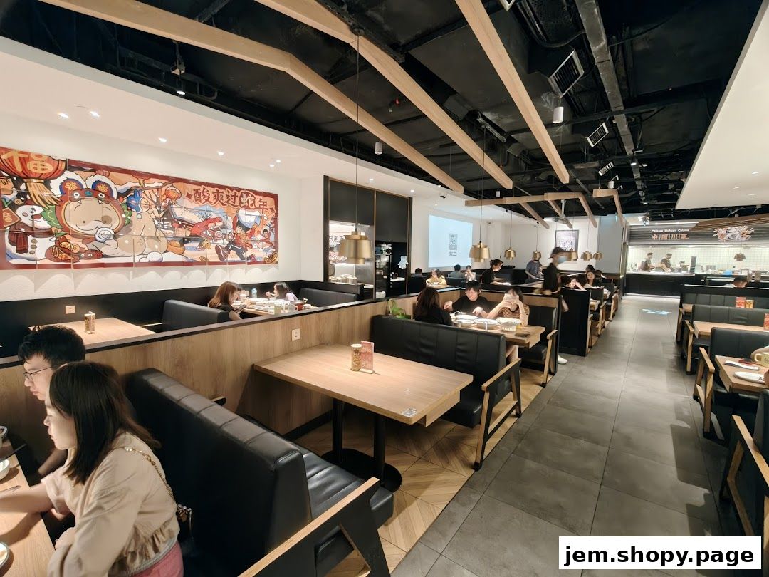 Interior view of a modern restaurant with booth seating and a vibrant mural.