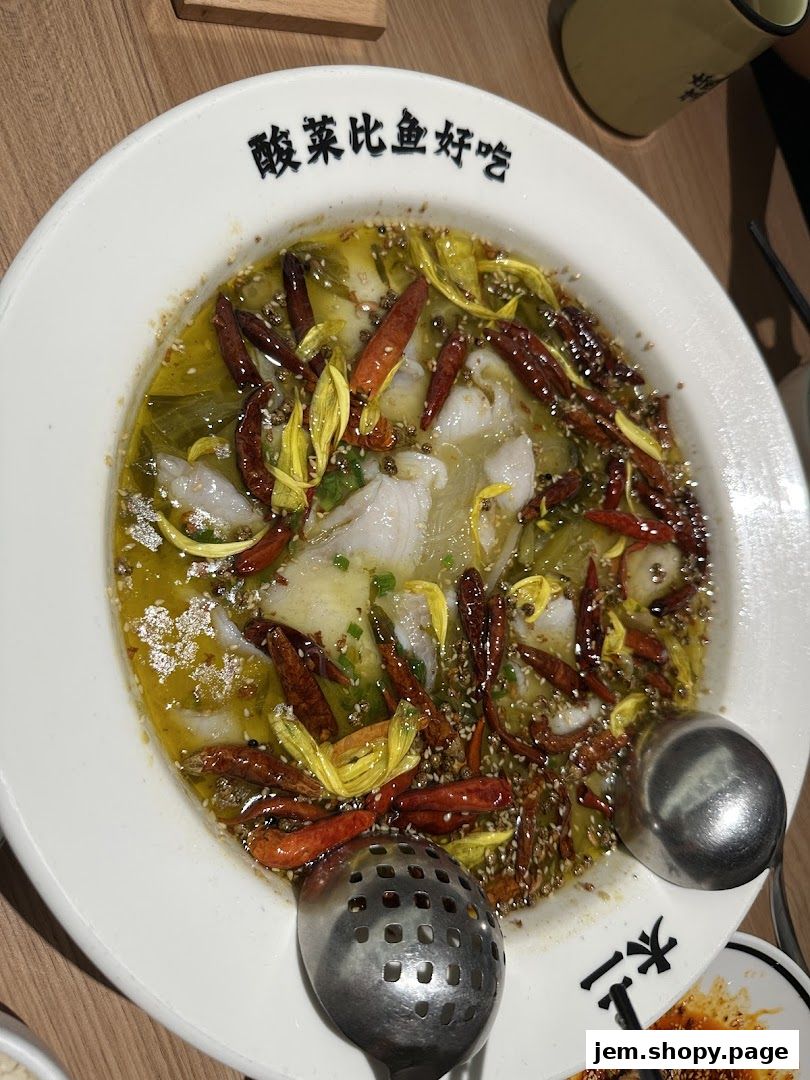 A close-up of a flavorful fish dish with chili peppers and herbs in a white bowl.