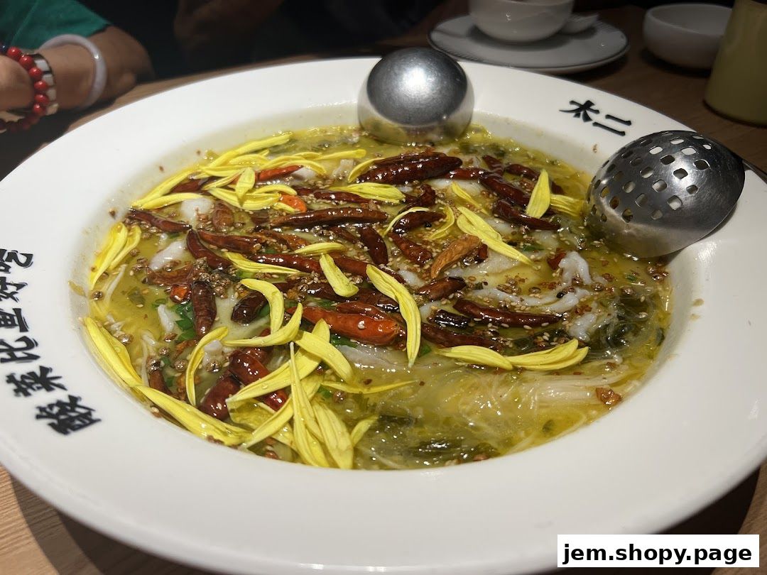 A close-up of a spicy fish dish with chili peppers and yellow flower petals.