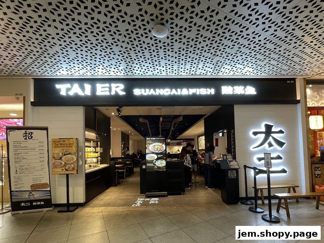The exterior of Tai Er Suancai & Fish restaurant with its prominent signage and menu displays.