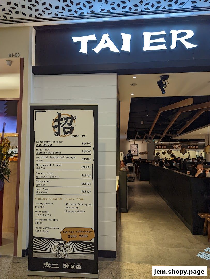The storefront of TAI ER, a restaurant, with a recruitment banner displayed.