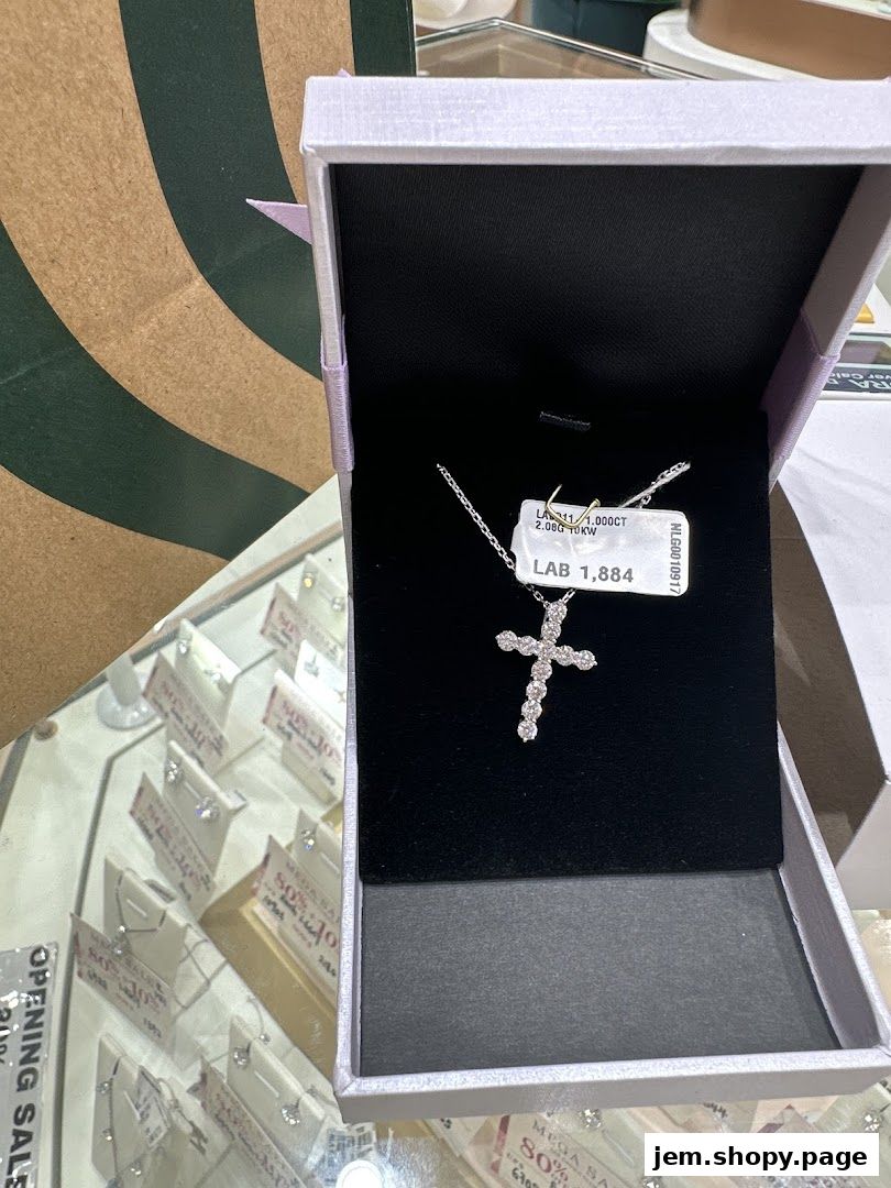A diamond cross pendant necklace displayed in an open jewelry box.