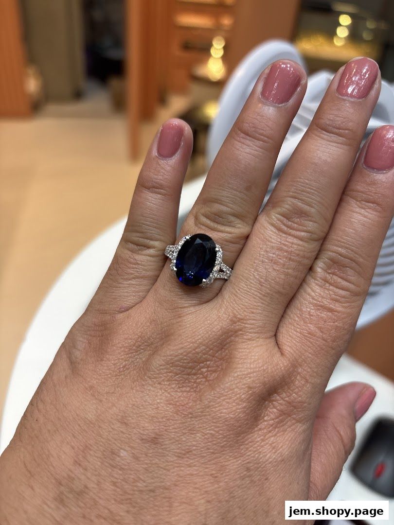 A hand wearing a large oval sapphire and diamond engagement ring.