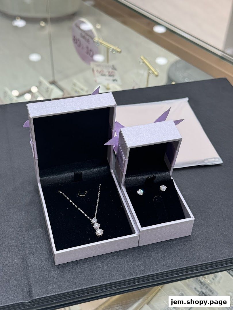 Elegant diamond necklace and earrings displayed in open jewelry boxes.