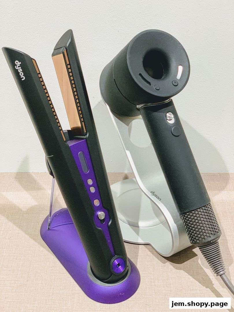 Dyson hair straightener and hairdryer displayed on stands.
