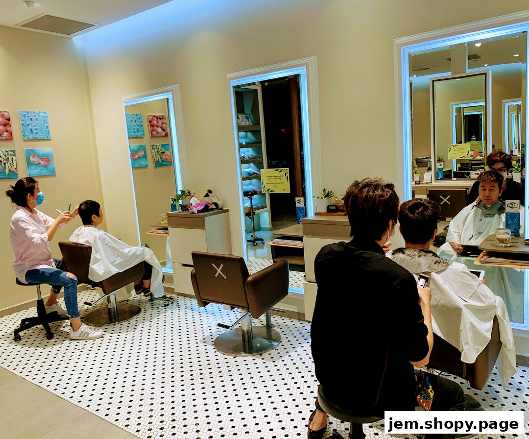 Hairdressers cutting hair for clients in a modern salon with mirrors and artwork.