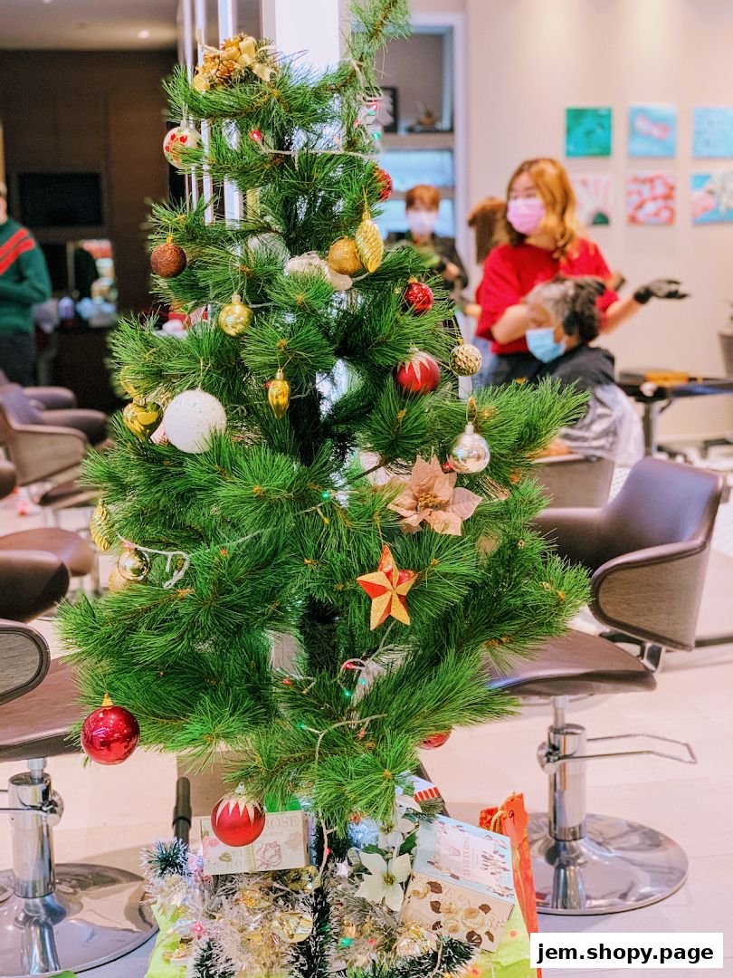 A decorated Christmas tree stands in a salon with staff and clients in the background.
