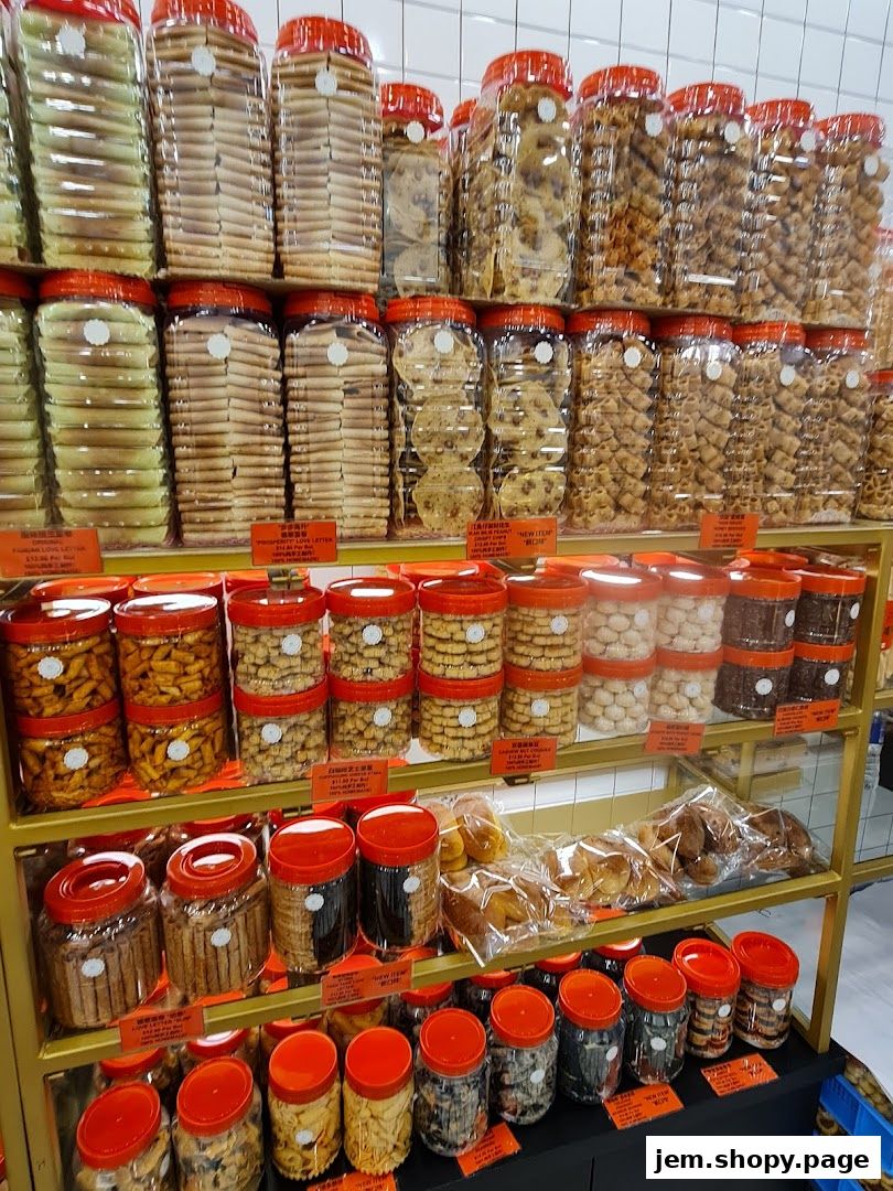 Shelves filled with various cookies and snacks in clear plastic jars with red lids.