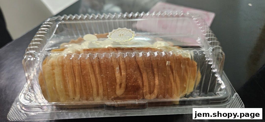 A delicious-looking pastry in a clear plastic container with a decorative label.