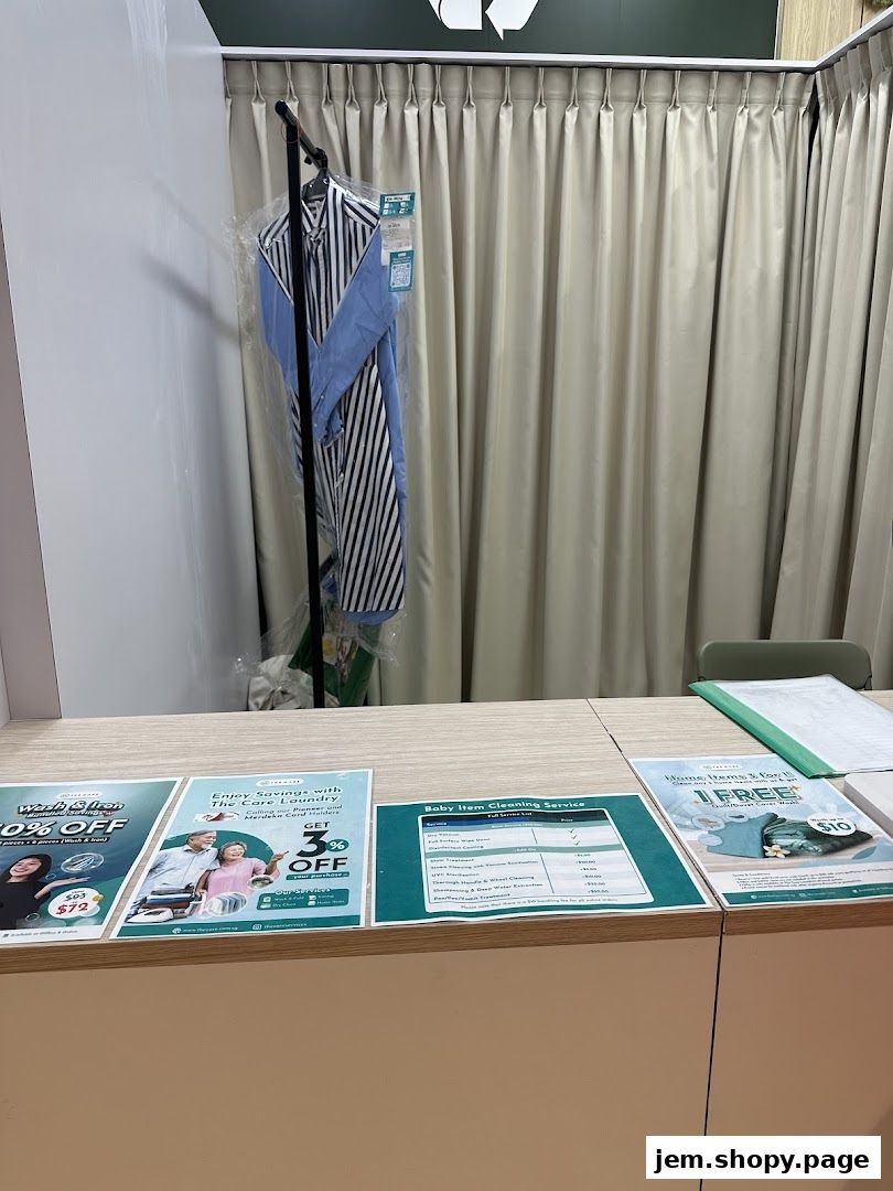 A counter with laundry service flyers and a garment on a hanger.