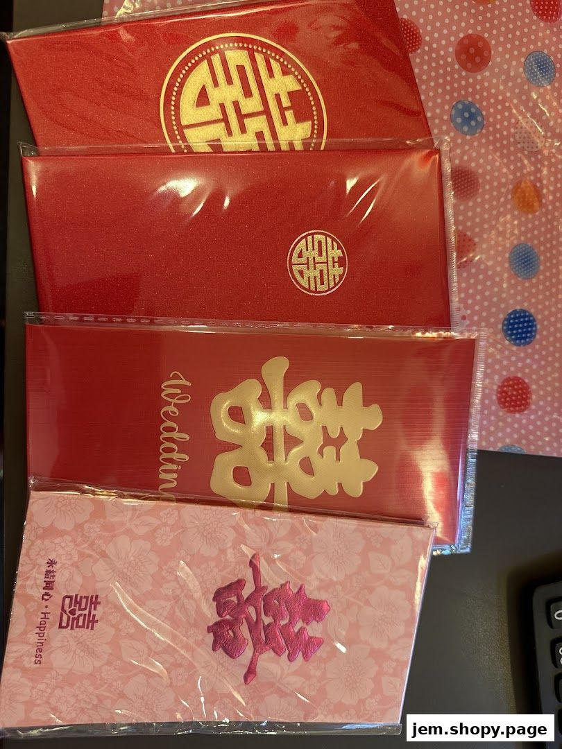 A collection of red and pink Chinese wedding envelopes with gold and pink lettering.