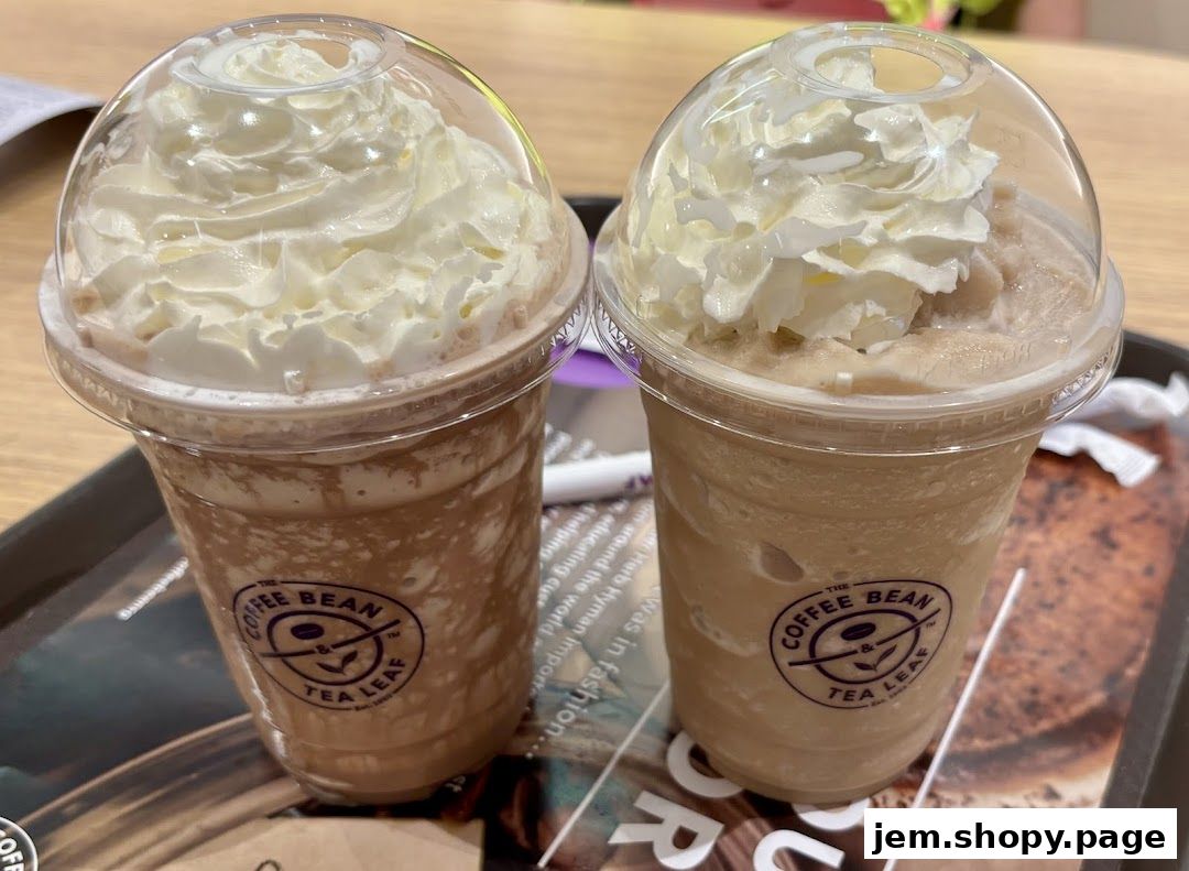 Two iced coffee drinks topped with whipped cream from The Coffee Bean & Tea Leaf.