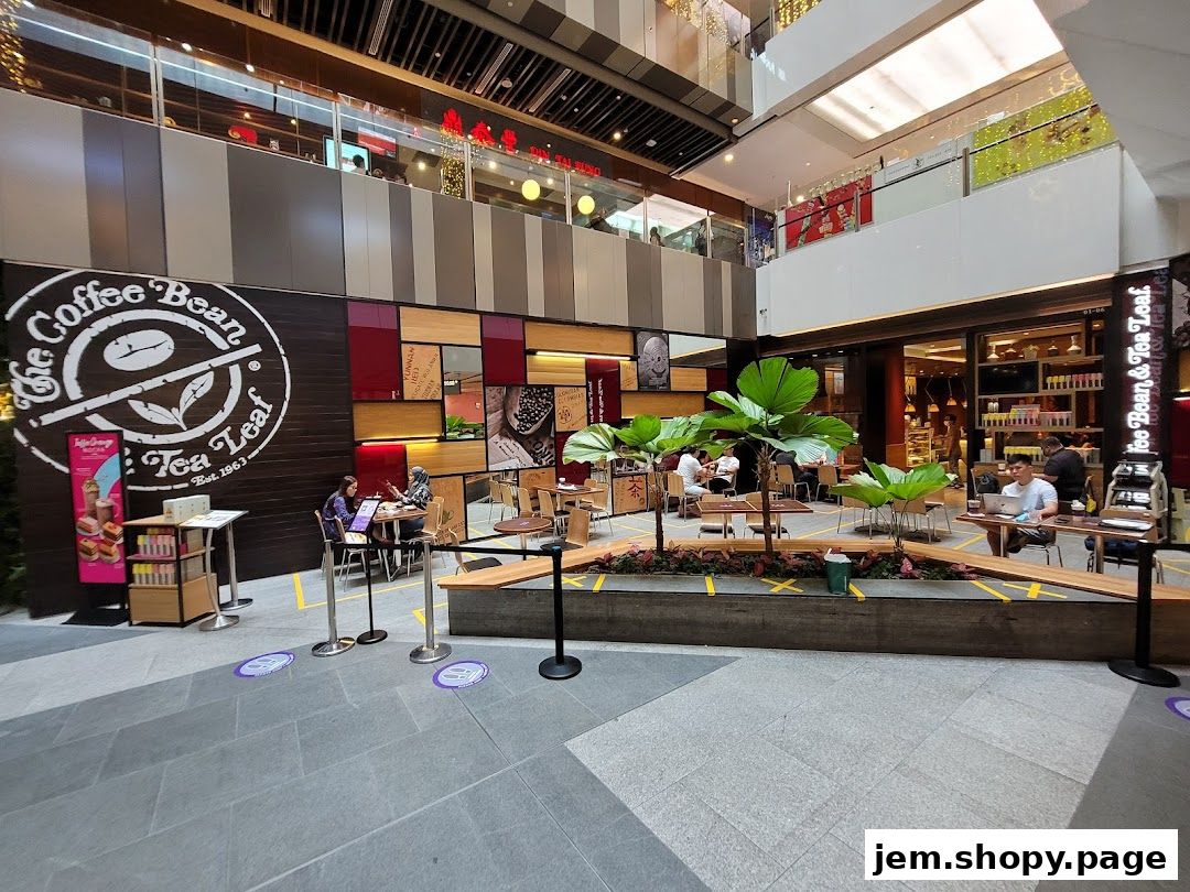 Interior view of The Coffee Bean & Tea Leaf cafe with seating areas and patrons.