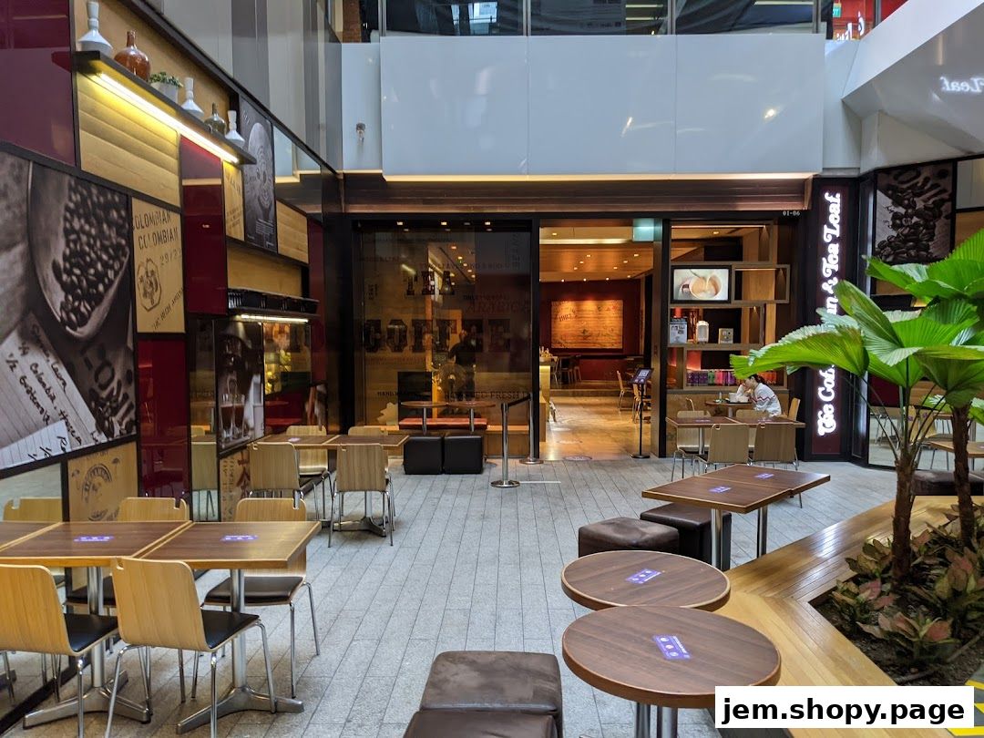 Exterior view of The Coffee Bean & Tea Leaf cafe with seating areas.