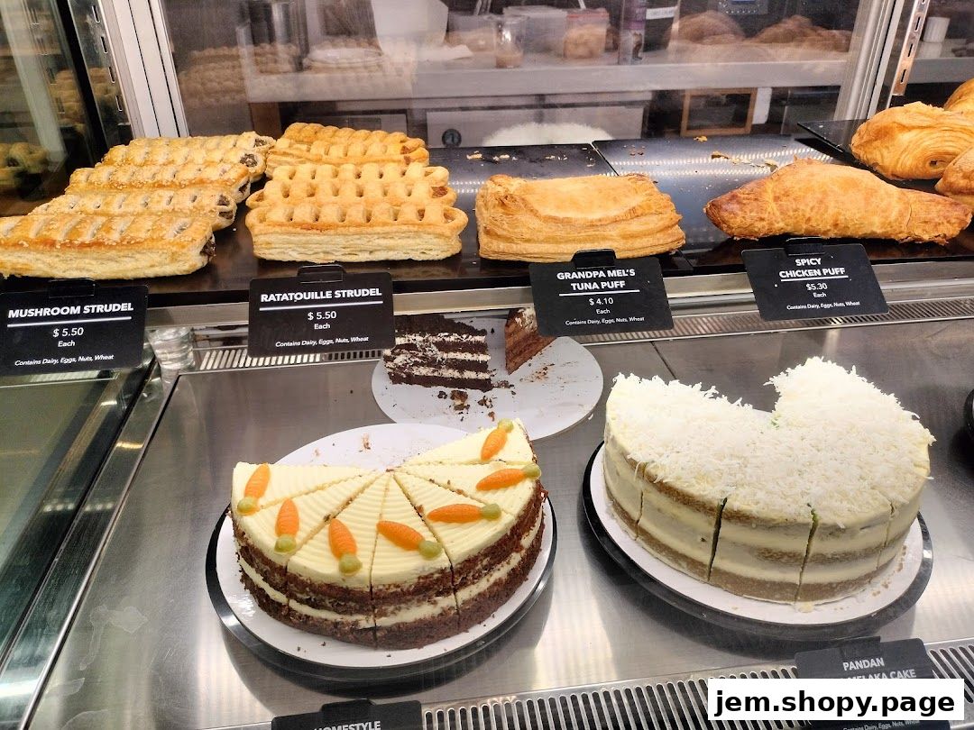 A display case filled with various pastries and cakes, including strudels, puffs, and layered cakes.
