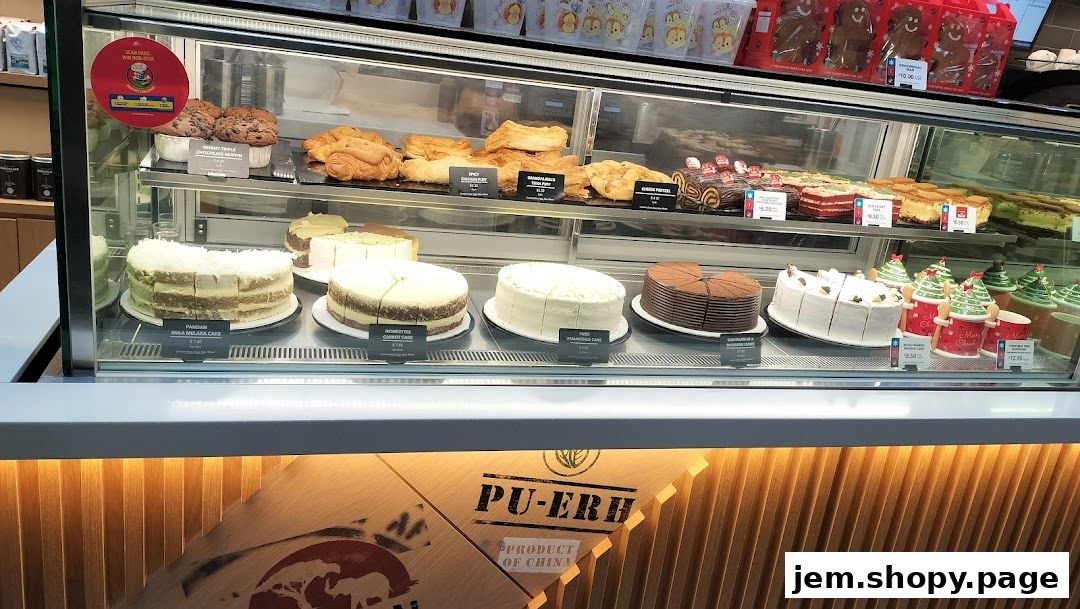 A display case filled with various cakes, pastries, and holiday-themed treats at The Coffee Bean & Tea Leaf.