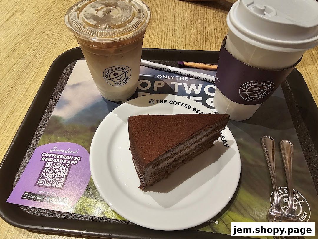 A slice of chocolate cake and two drinks on a tray at The Coffee Bean & Tea Leaf.