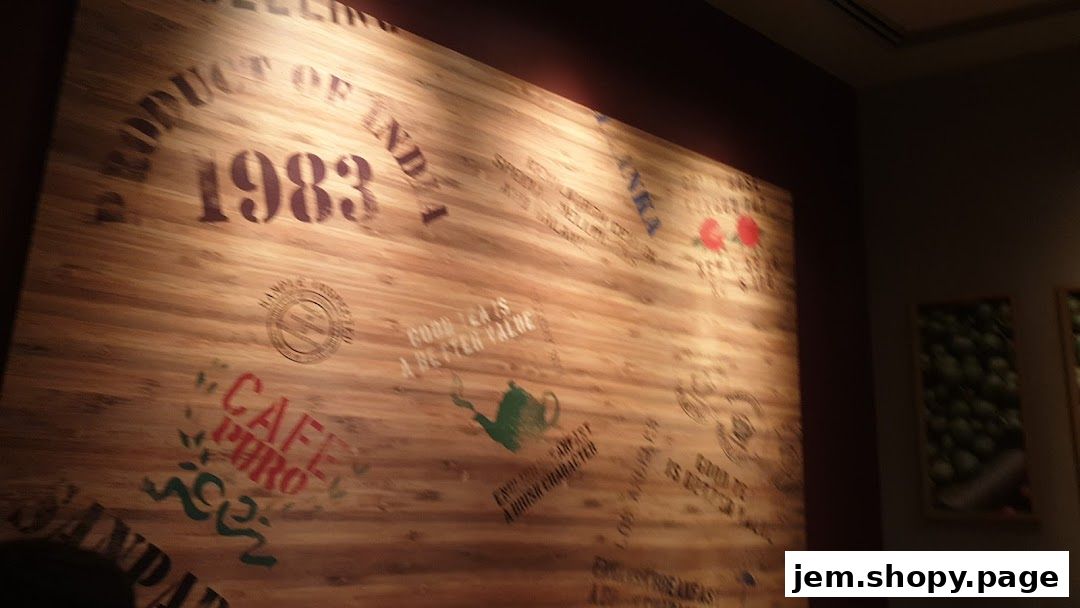 A wooden wall with vintage coffee and tea branding, including the year 1983.