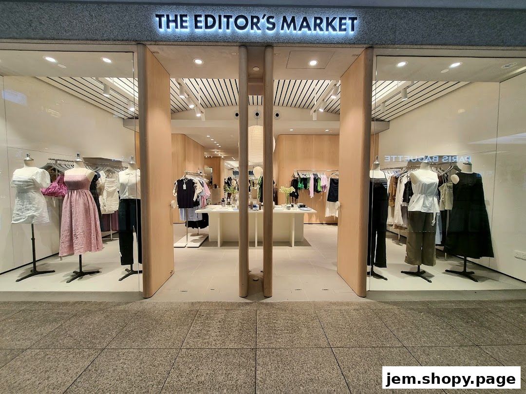 The entrance of THE EDITOR'S MARKET clothing store, showcasing mannequins with stylish apparel.