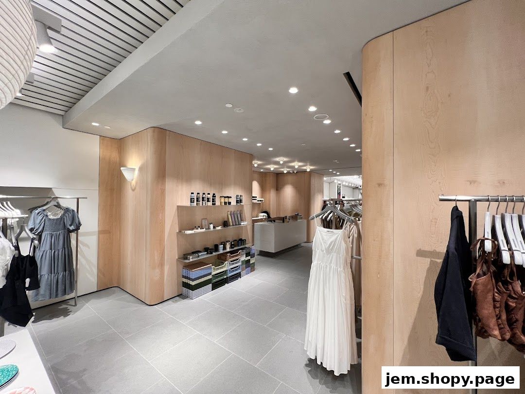 Interior view of a modern boutique with clothing racks and shelves displaying merchandise.