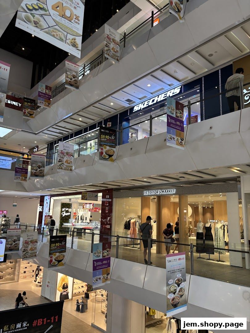 Interior view of a shopping mall with various shops and displays, including The Editor's Market.