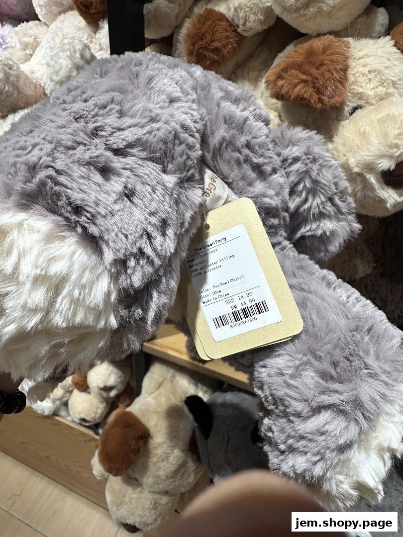 A close-up of a fluffy grey plush toy with a price tag attached.