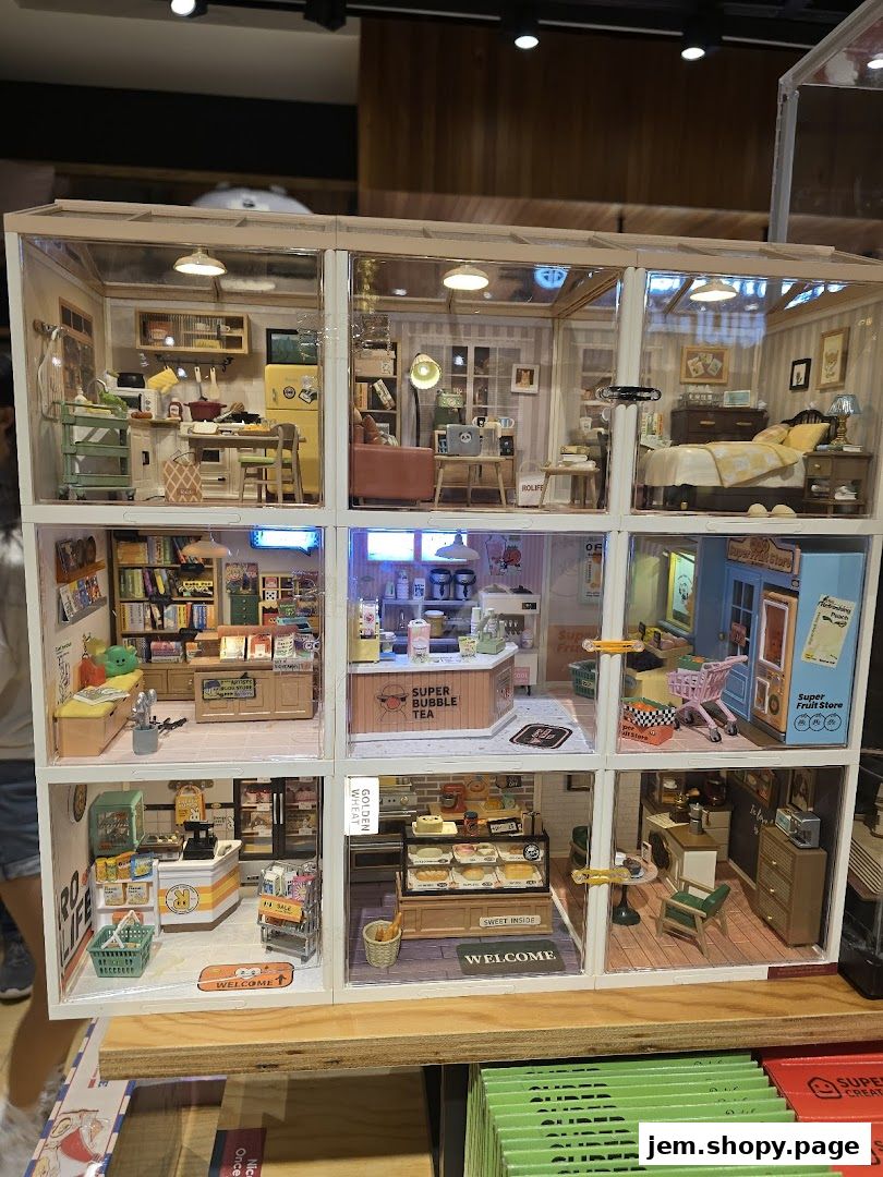 A detailed miniature diorama showcasing various shop interiors and living spaces.