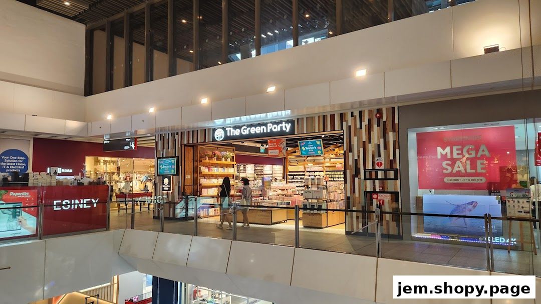 The Green Party shop entrance with displays of various products and two customers browsing.