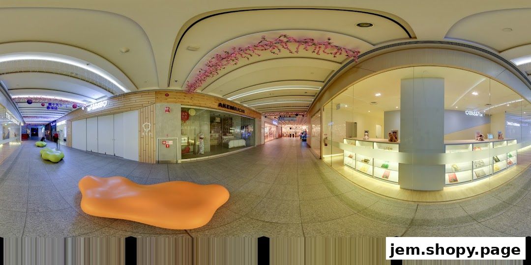 A wide view of a shopping mall corridor with several shops visible, including The Learning Lab.