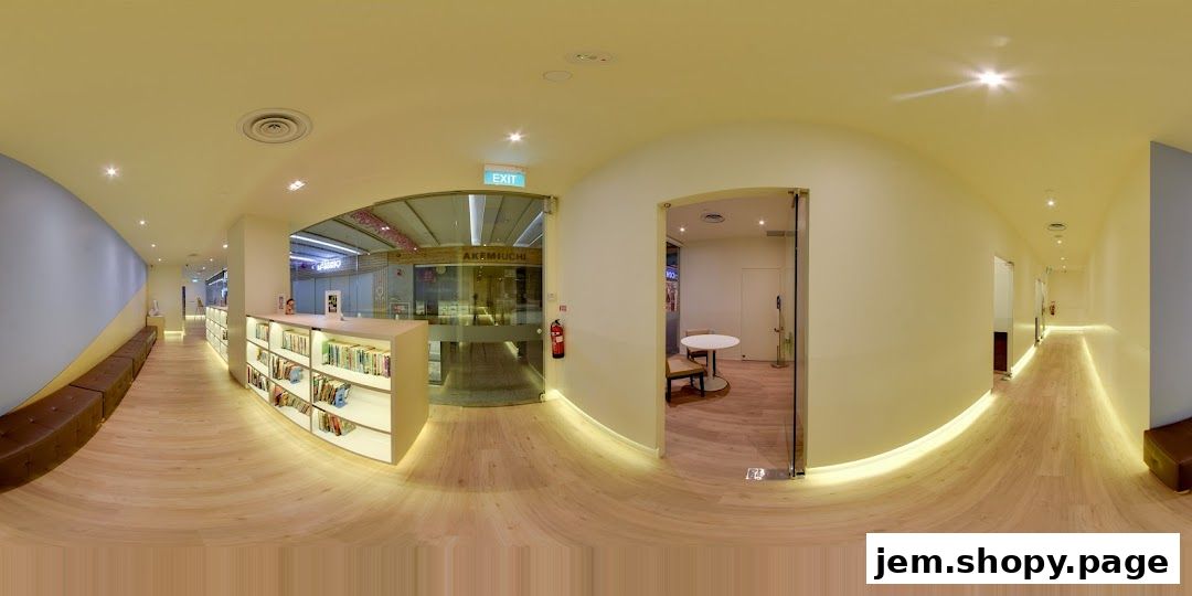 Interior view of The Learning Lab JEM, showcasing bookshelves, seating, and an entrance to another shop.