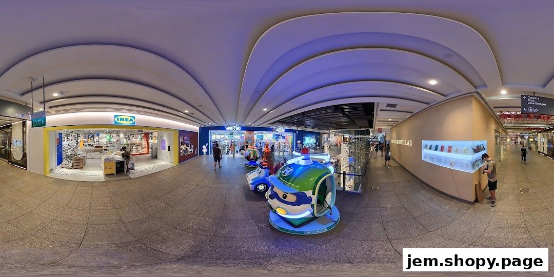 A wide view of a mall corridor featuring IKEA, Toys R Us, and The Learning Lab.