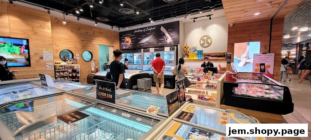 Interior of a seafood market with frozen seafood displays and a checkout counter.