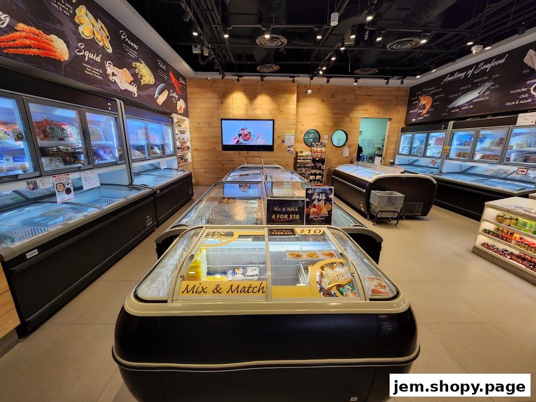 Interior view of a seafood market with refrigerated display cases filled with various seafood products.