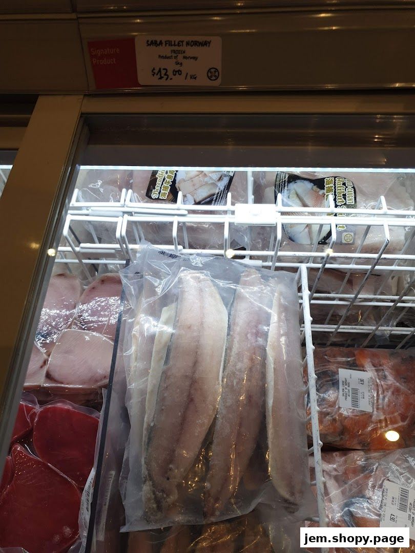 Frozen Saba Fillet Norway is displayed in a refrigerated section of a seafood market.
