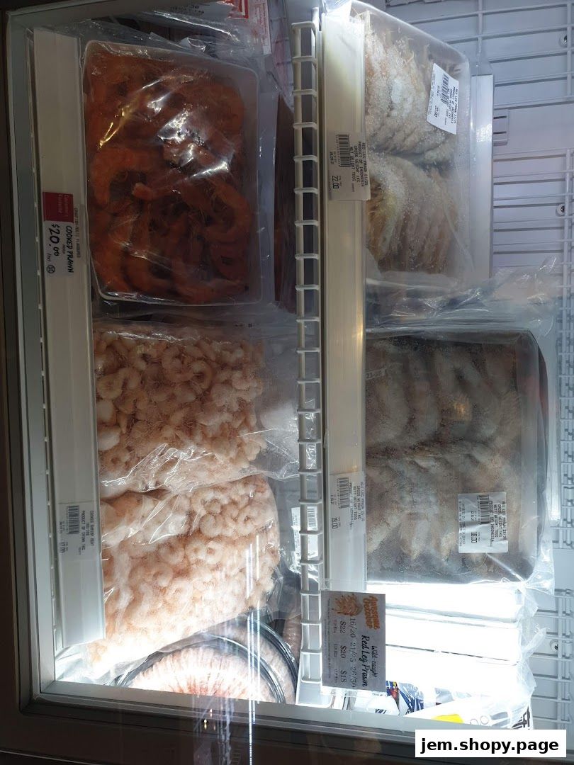 A display freezer filled with various types of frozen prawns and seafood.