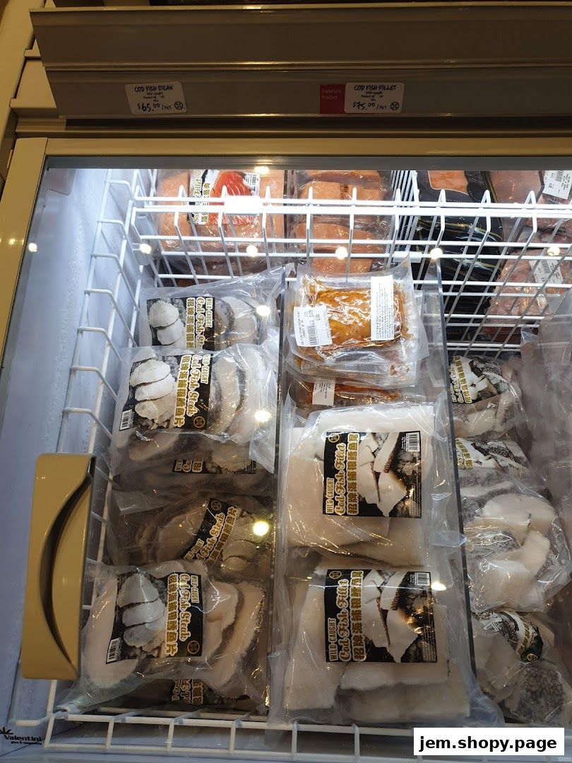Frozen seafood products, including cod fish steaks and fillets, displayed in a refrigerated case.
